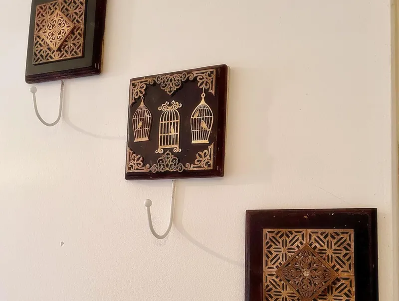 Wooden wall plaques with hooks hung on a white wall